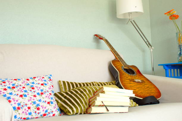istock Reading an interesting novel in a comfortable chair or learning how to play the guitar 1215476019