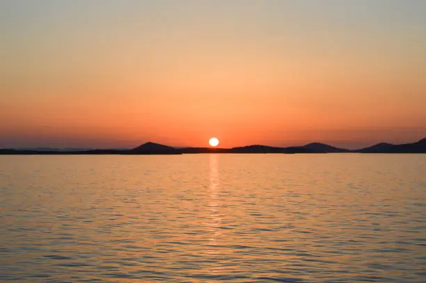 Beautiful sunset over the Adriatic sea with reflection, Zadar region, Croatia