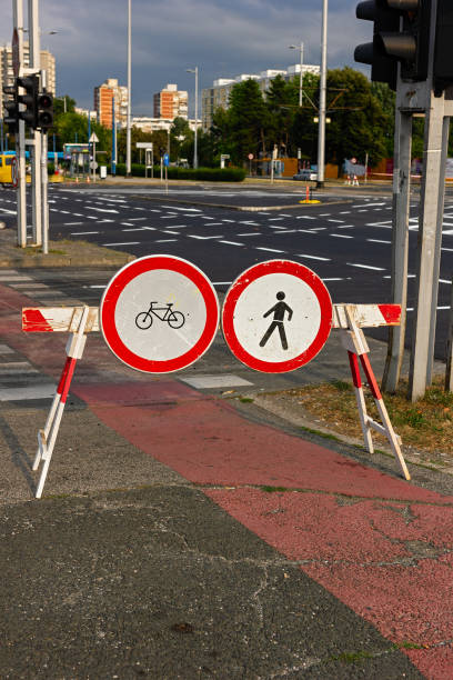 istock Traffic signs on a road barrier prohibiting people and bicycles going forward 1215477585