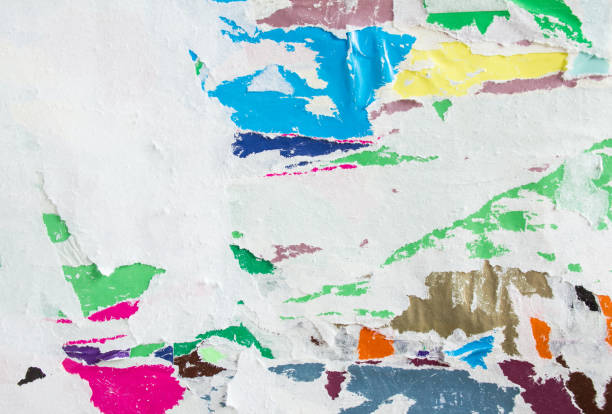 istock Torn crumpled and peeling old paper layers on billboard texture background. 1215477689