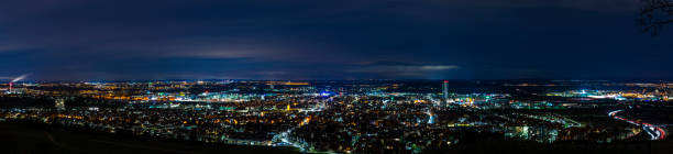 Germany, XXL panorama aerial view above houses, skyline and streets of fellbach city near stuttgart, illuminated cityscape by night stock photo