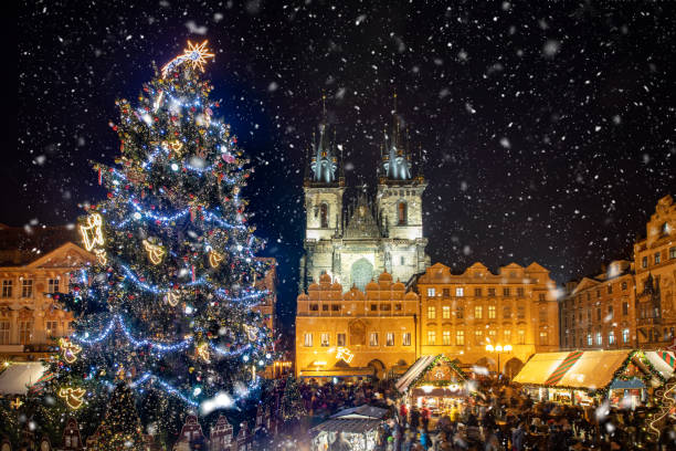 Beautiful view to the old town square of Prague during night time with a Christmas market Beautiful view to the old town square of Prague during night time with a Christmas market in winter time with snow falling, Czech Republic prague christmas market stock pictures, royalty-free photos & images