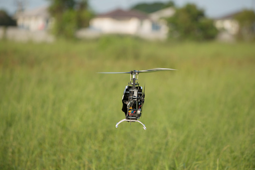 Radio controlled helicopter on the lawn background