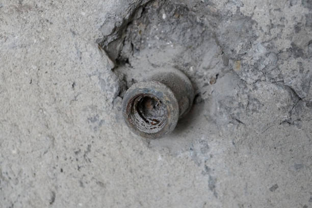 istock a pipe sticks out of an old concrete wall 1215487645
