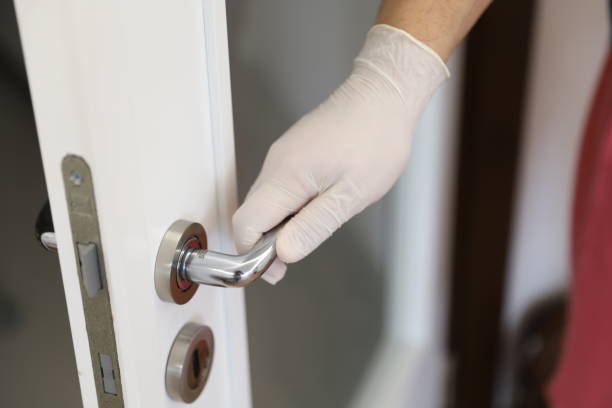 istock Touching the common places with gloves to protect from Coronavirus 1215490020
