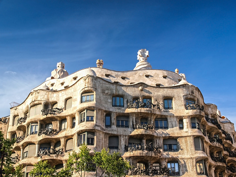 Barcelona, Spain - April 18th, 2010: Front view of Casa Mila (La Pedrera), the famous building designed by the architect Gaudi. One of the most popular touristic landmarks of Barcelona.