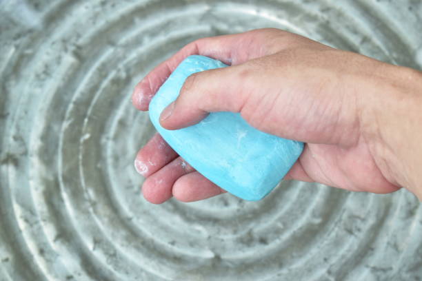 istock hand holding soap for washing with water 1215494867