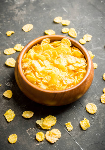 istock Tasty crispy corn flakes in bowl on the rustic background 1215495171