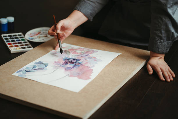 istock Woman drawing on the floor of design studio. 1215496102