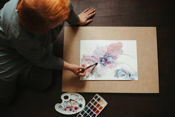 Woman drawing on the floor of design studio.
