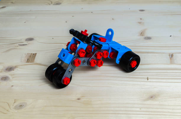 istock three-wheeled motorcycle built with plastic meccano on wooden background 1215499112