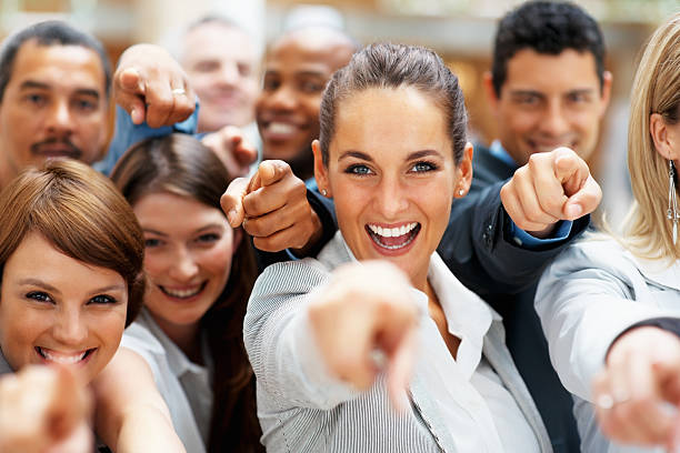 istock Happy group of executives pointing at you 121549932