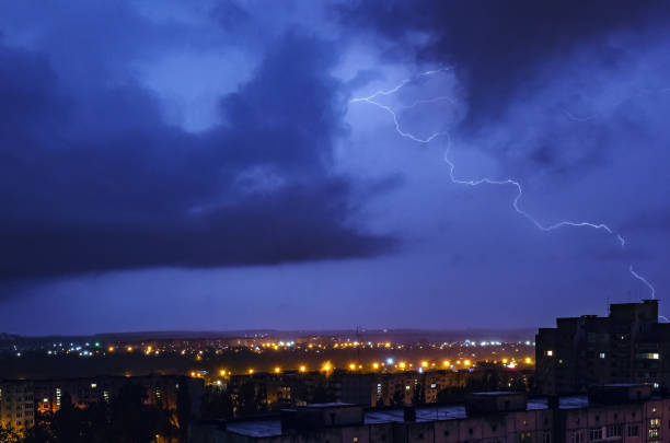 istock Thunderstorm with lightning and thunder over the night city 1215500356