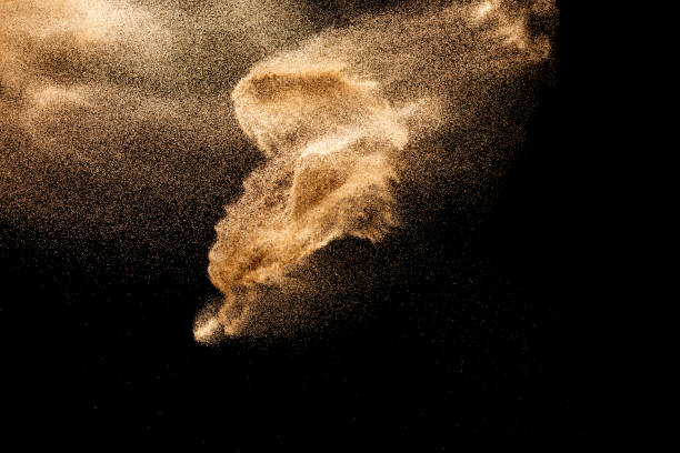 istock Brown colored sand splash.Dry river sand explosion isolated on black background. Abstract sand cloud. 1215500578