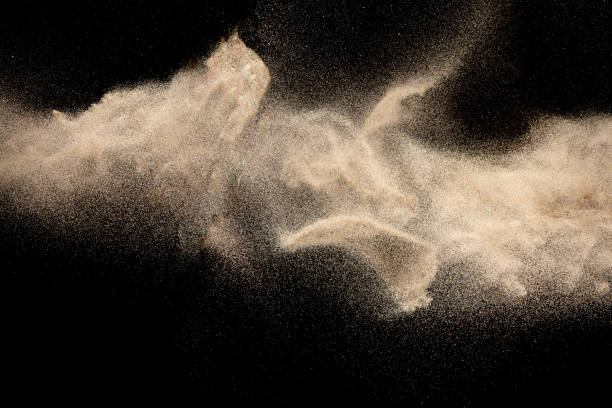 istock Brown colored sand splash.Dry river sand explosion isolated on black background. Abstract sand cloud. 1215500604