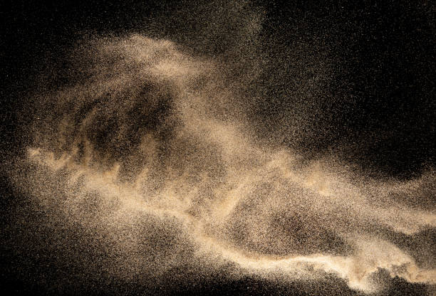 istock Brown colored sand splash.Dry river sand explosion isolated on black background. Abstract sand cloud. 1215500627