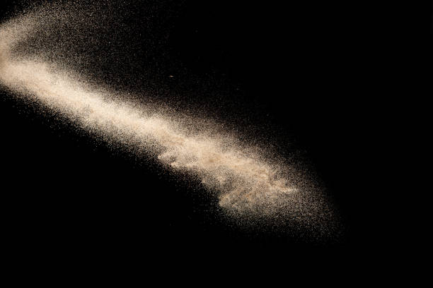 istock Brown colored sand splash.Dry river sand explosion isolated on black background. Abstract sand cloud. 1215501321