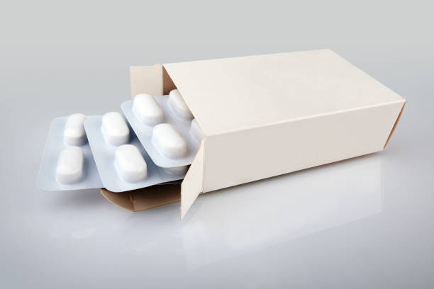 istock Pills blister getting out from the box over Gradient background 1215503319