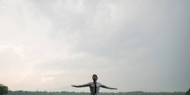 istock Young businessman relaxing under grey sky 1215503348