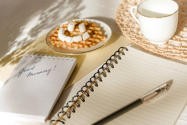istock Marshmallow waffle smile ' '2 greeting card good morning on white textured table. 1215503584