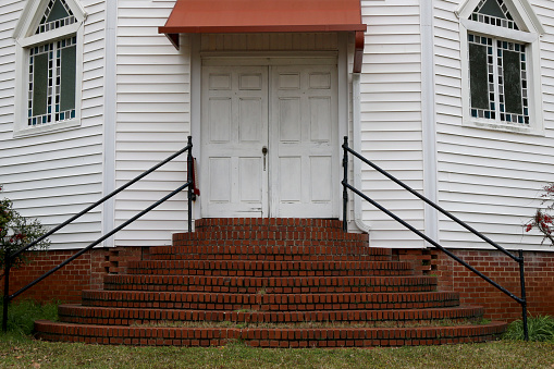 an old set of southern church doors with brick steps