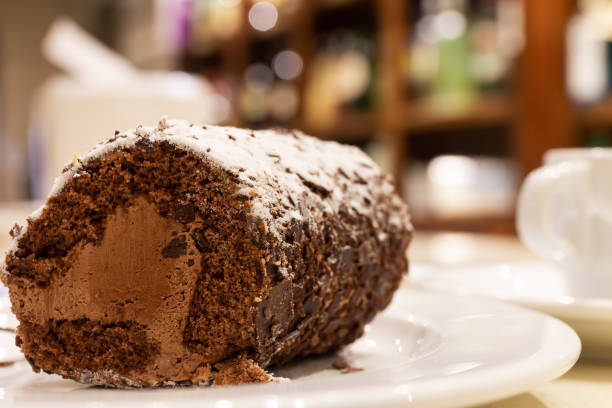 istock Chocolate roll cake and truffle decorated with sheets of chocolate and icing sugar 1215506052