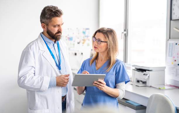 istock A dentist with dental assistant in modern dental surgery, working. 1215506314