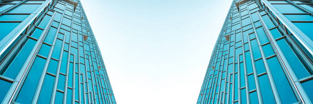istock underside panoramic and perspective view to steel Tiffany blue glass high rise building skyscrapers, business concept of successful industrial architecture 1215507302