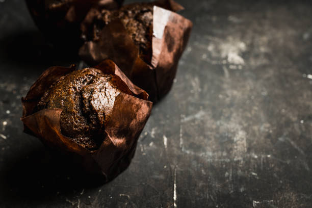 istock Homemade chocolate muffin on the rustic background 1215507819