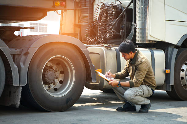 asian truck driver holding clipboard inspecting safety vehicle maintenance checklist a truck wheels, tire - service rig imagens e fotografias de stock