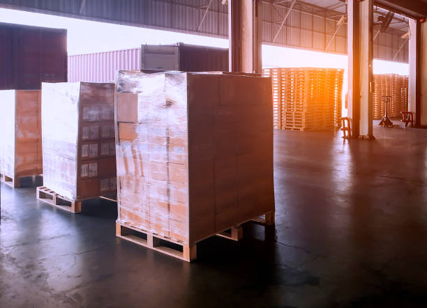 istock Interior of shipping warehouse area, Stack of package boxes on pallet waiting to load into a truck, Road freight industry delivery shipment logistics and transport 1215510044
