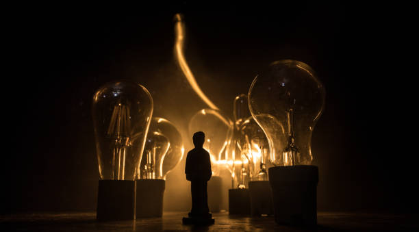 istock Abstract dark background with creative artwork decoration of glowing bulbs. 1215512387