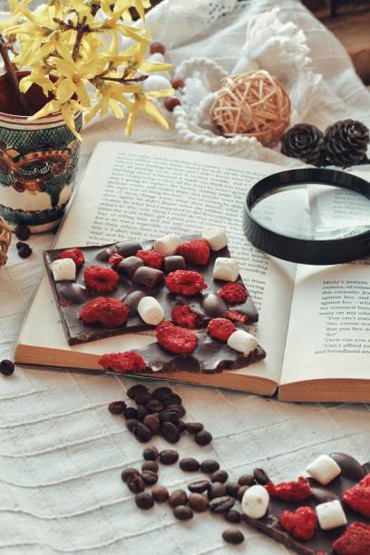 istock Crafted handmade chocolate bar with marshmallow and berries, coffee beans and good book 1215515827
