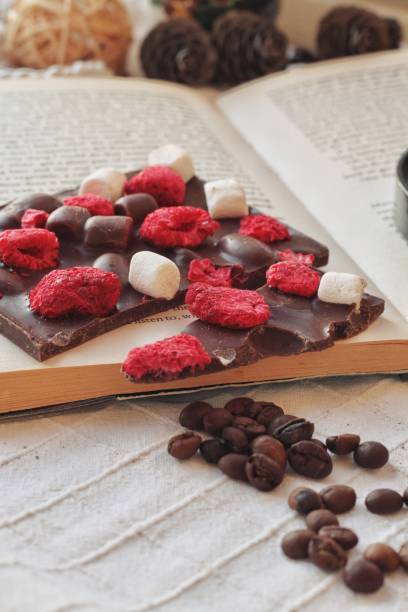 istock Crafted handmade chocolate bar with marshmallow and berries, coffee beans and good book 1215516033