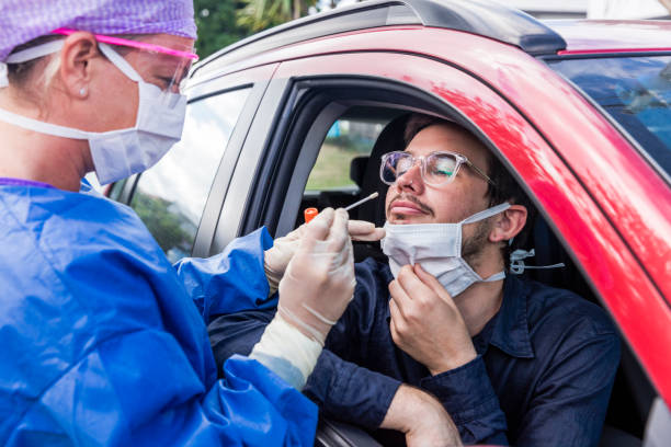 istock A doctor taking a nasal swab from a driver 1215518849