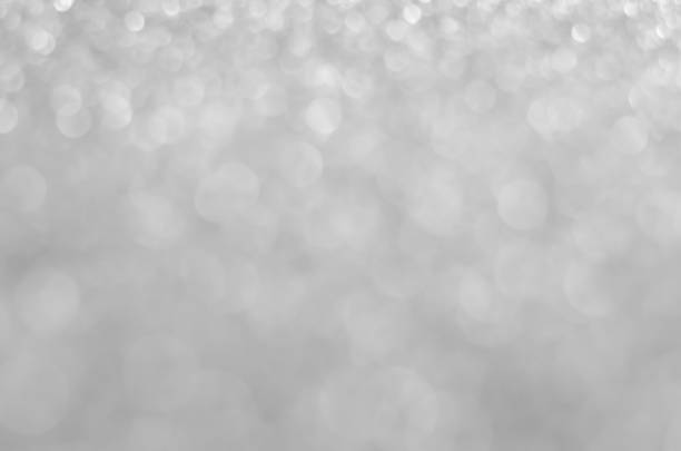 istock abstract white blur bokeh glitter sparkle no color background. 1215520736