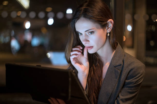 istock Pensive tablet night woman 1215522034