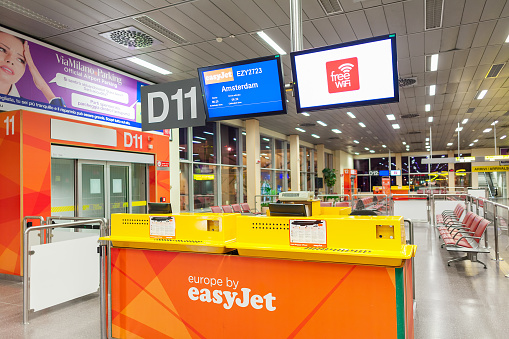 MALPENSA, ITALY - JULY 07, 2015: Easyjet counter at boarding gate Terminal 2 of Malpensa Airport - largest international airport in Northern Italy and  28th busiest in Europe in terms of passengers.