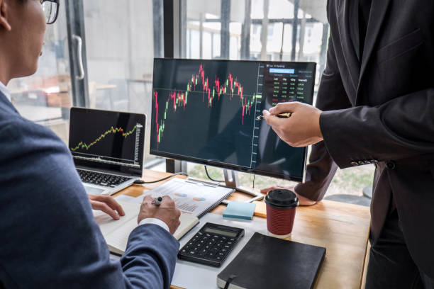 istock Business team partner working with computer, laptop, discussion and analyzing graph stock market trading with stock chart data planning, financial and investment concept 1215522937