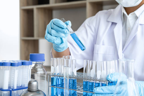 istock Scientist or medical in lab working in biotechnological laboratory using equipment for research with mixing reagents in glass flask in clinical laboratory 1215523361