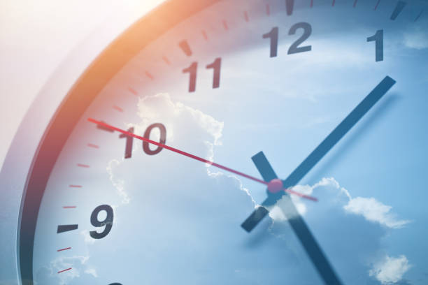 istock Day times clock overlay double exposure with blue sky. 1215525588