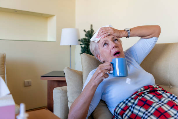istock Senior  Woman With Flu Lying at Home 1215527577