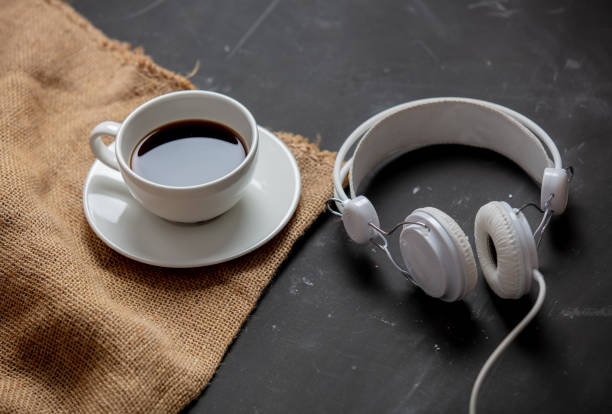 istock Cup of coffee and headphones on a table 1215528319