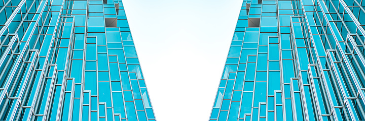 underside panoramic and perspective view to steel Tiffany blue glass high rise building skyscrapers, business concept of successful industrial architecture