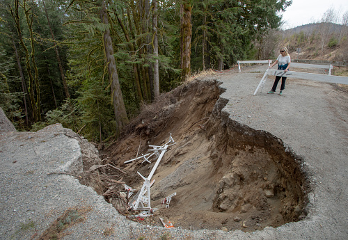 The road has been worn down by floods and mud slides