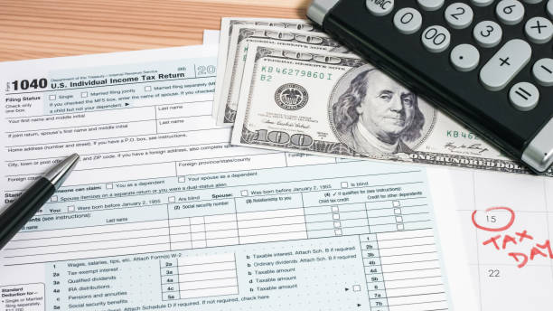 istock 1040 tax return with money 1215531016