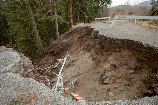 The road has been worn down by floods and mud slides