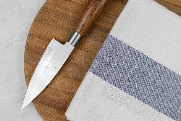 istock Flatlay above kitchen dishcloth and knife on the wooden board 1215532469