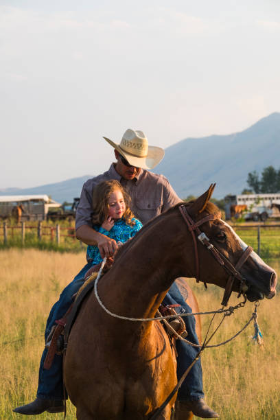 istock Parents Riding Horses With Their Daughters 1215532545