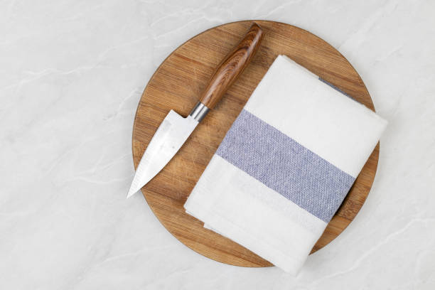 istock Flatlay above kitchen dishcloth and knife on the wooden board 1215532661